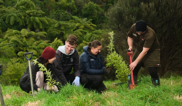 Four GW staff members at a planting day, planting seedlings 