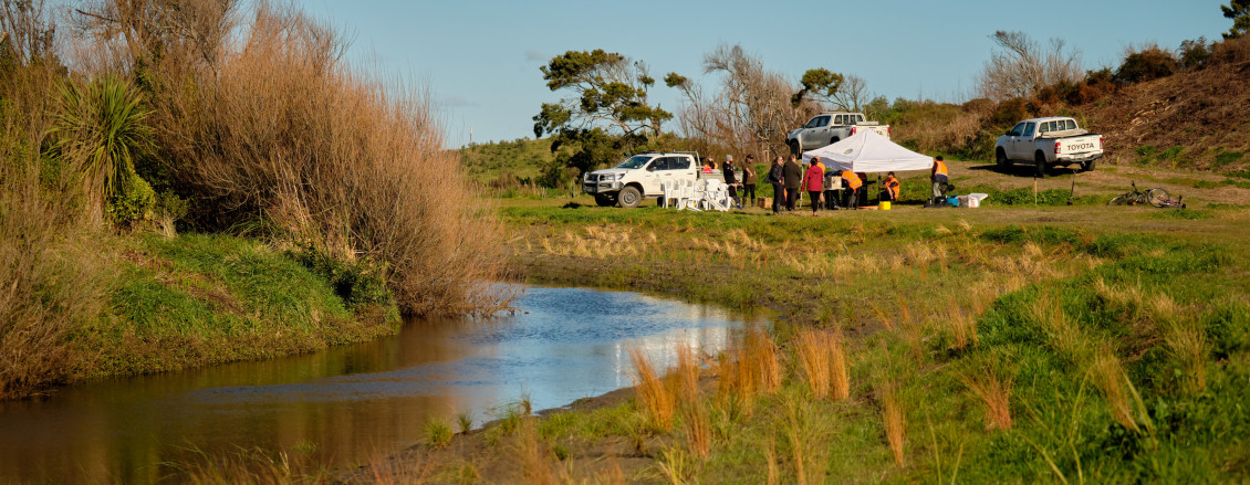 Wide shot of the planting day crew and the river