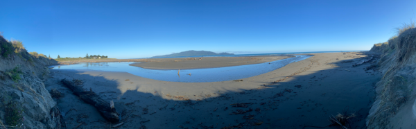 View of Waimeha Stream’s position on Waikanae Beach, seen from the dune near Field Way and facing west toward the sea, with Kāpiti Island visible on the horizon.