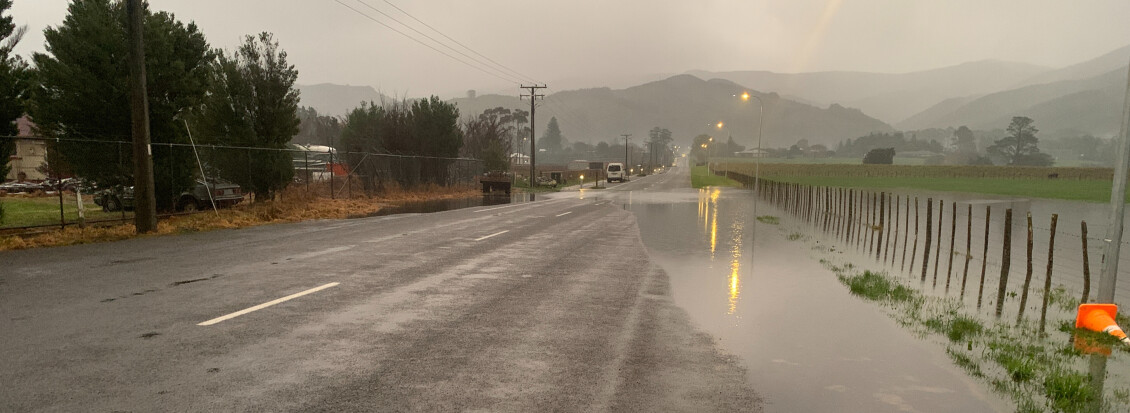 Flooding in Featherston along the berm between a road and a field