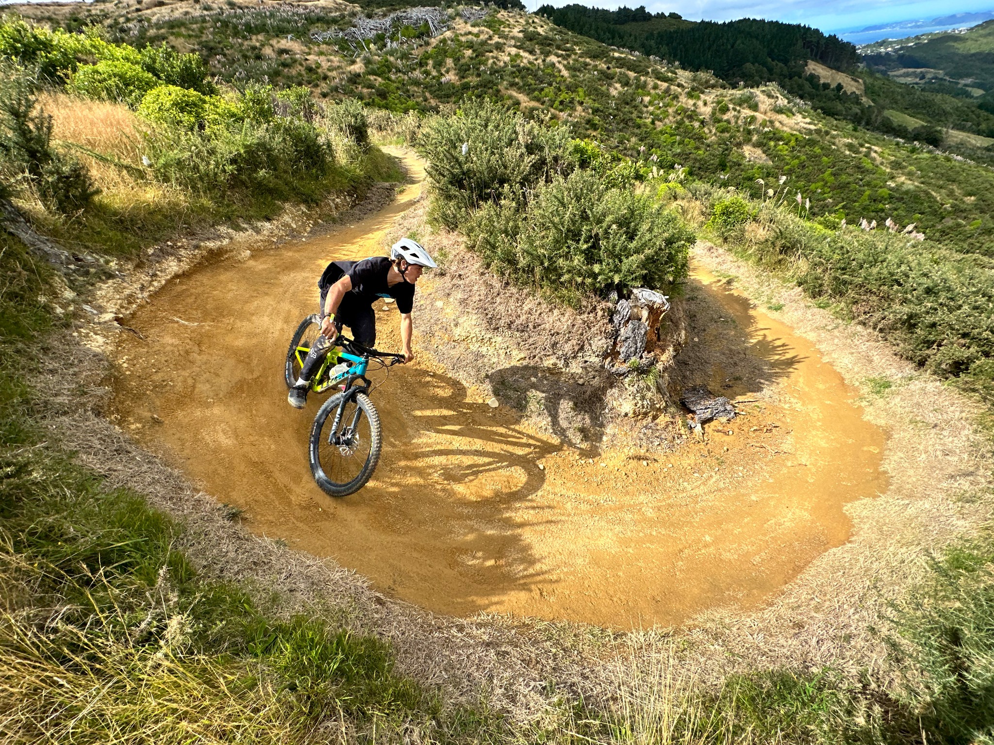 A mountain biker cycles down a dirt track
