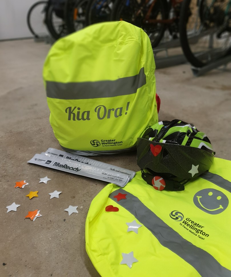 Reflective items - a backpack cover, snap bracelets/anklets, and star stickers