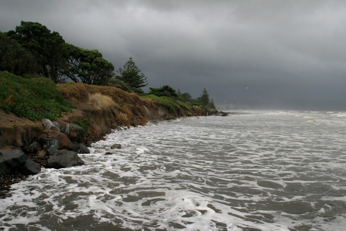 The coast at Paraparaumu with choppy water and a dark sky