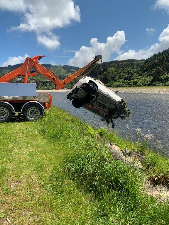A crane retrieving a car from the river