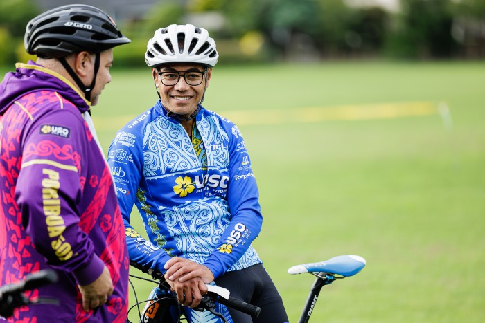 Two USO cyclists lean against their bikes