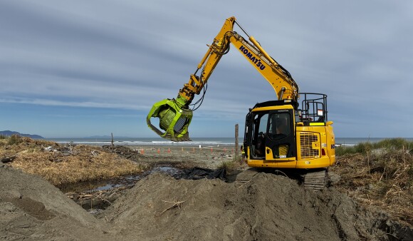 Digger excavating Phragmites karka (common reed) at Lake Waiorongomai