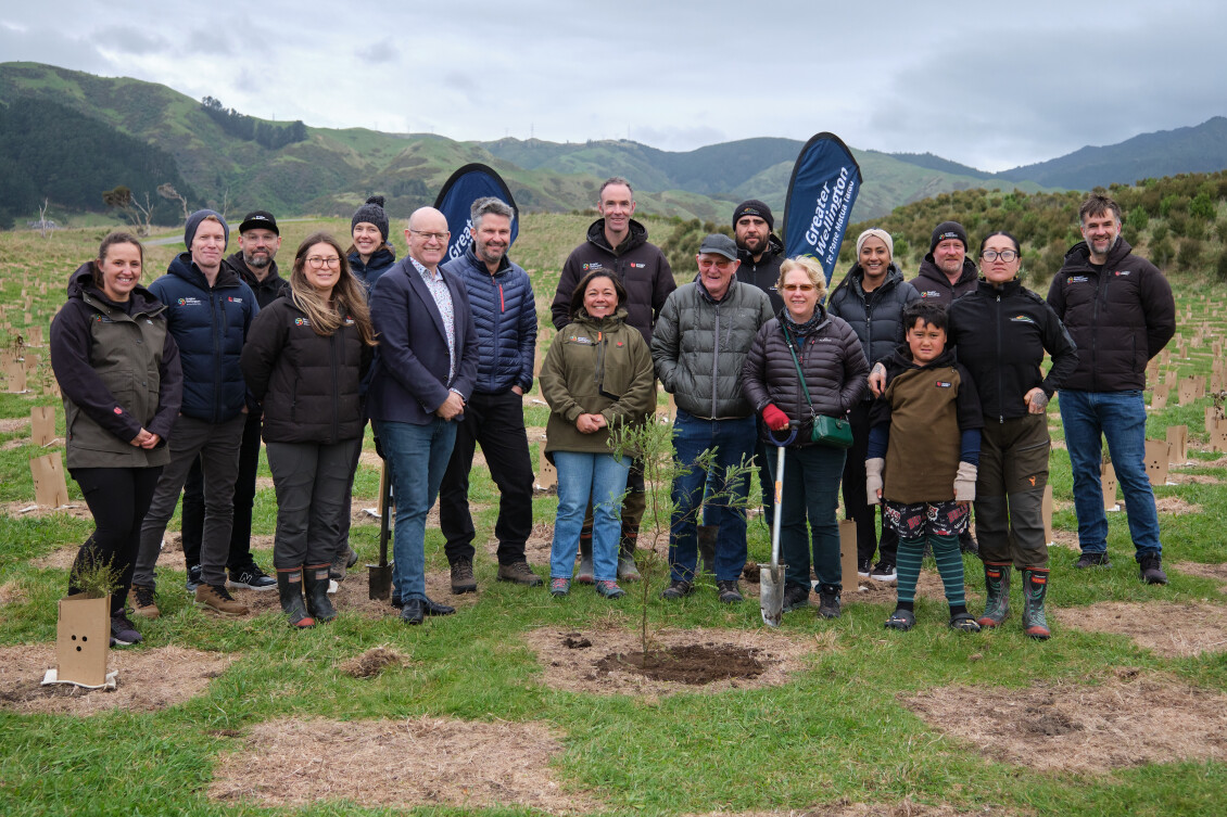 Chair Daran Ponter, Park ranger Jordan Clear, Greater Wellington staff, mana whenua and community members pose with the millionth native tree planted in regional parks